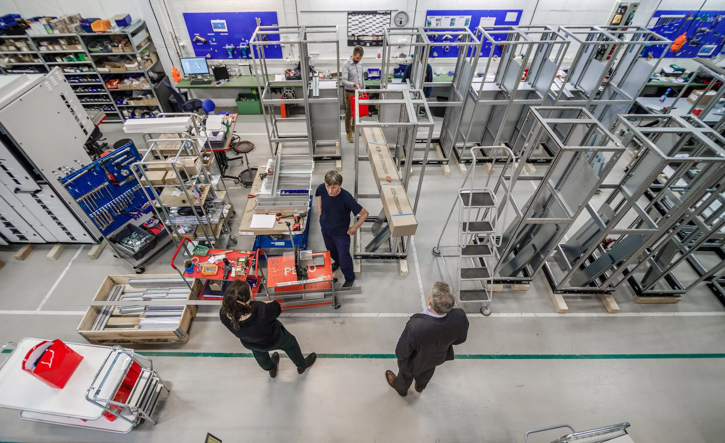 Inside the Northern Islands Technology workshop — engineers assembling electrical panels and automation systems