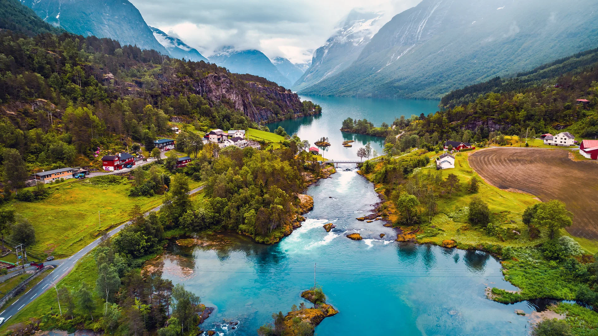 Norwegian mountain landscape with green valleys and a river flowing between steep peaks