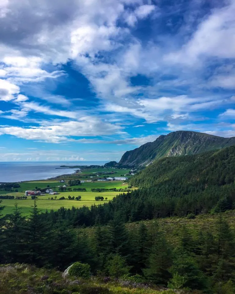 Lush green valley and mountain ridge at Nordøyane