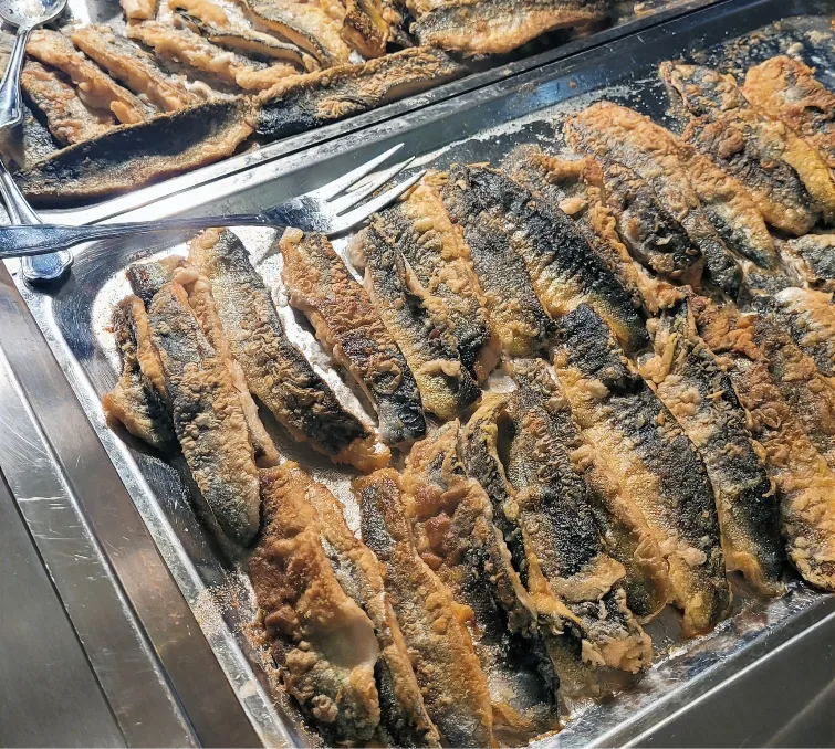 Rows of freshly fried bleke salmon on a serving tray at Hotel Revsnes in Bygland