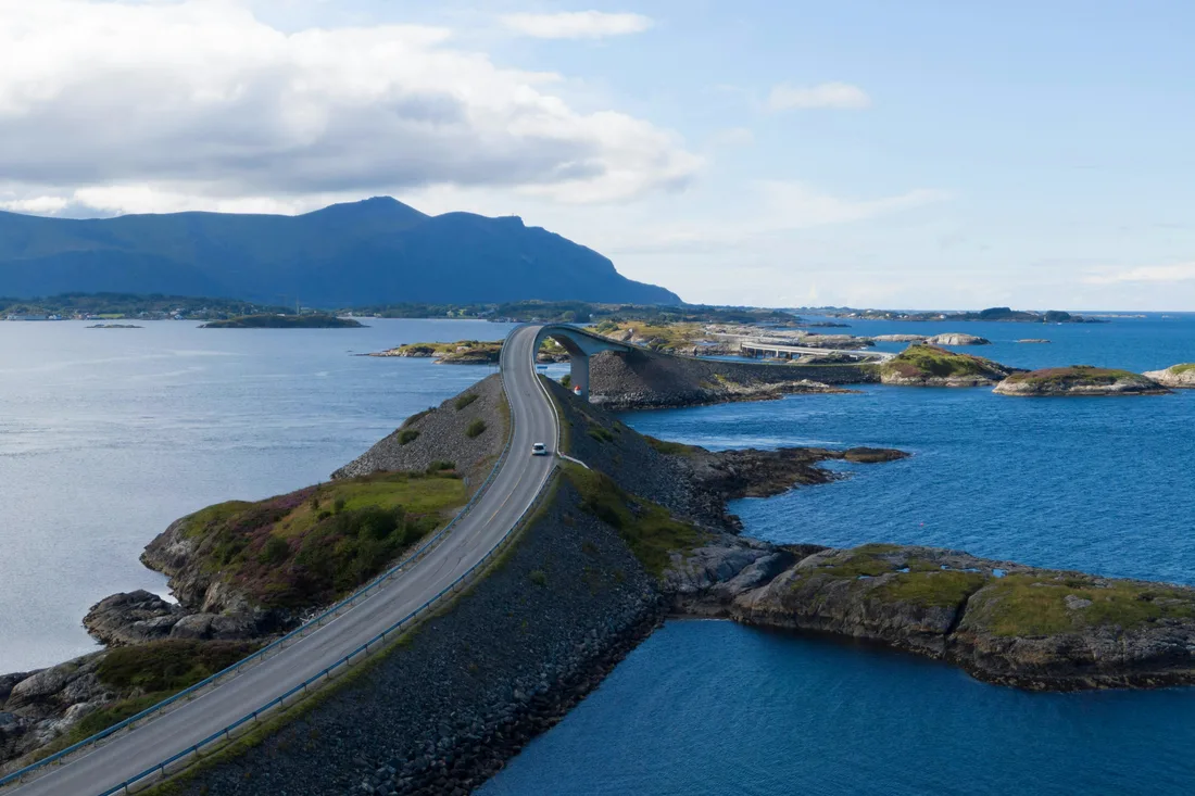 The Atlantic Ocean Road bridge arching over turquoise water in summer, a famous Norwegian scenic drive
