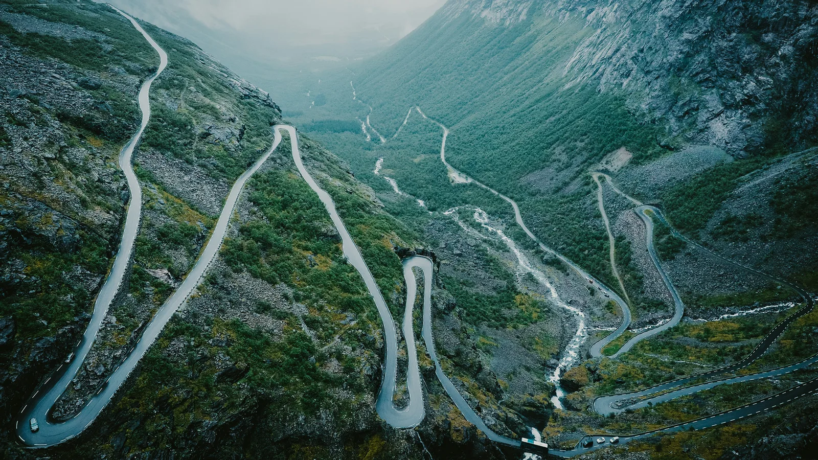 Aerial view of Trollstigen mountain road winding through misty Norwegian mountains