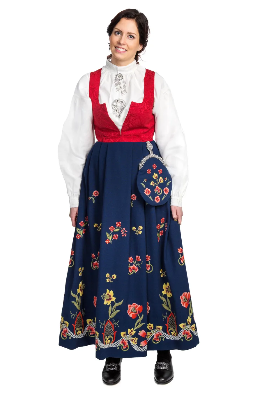 A woman wearing a modern version of the Graffer bunad with a red brocade bodice, white shirt with filigree silver, and blue embroidered skirt