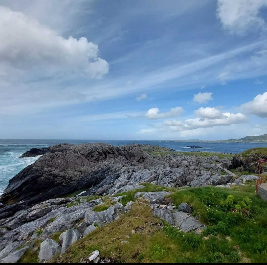 Haramsøy island surrounded by open sea with green mountains and dramatic clouds