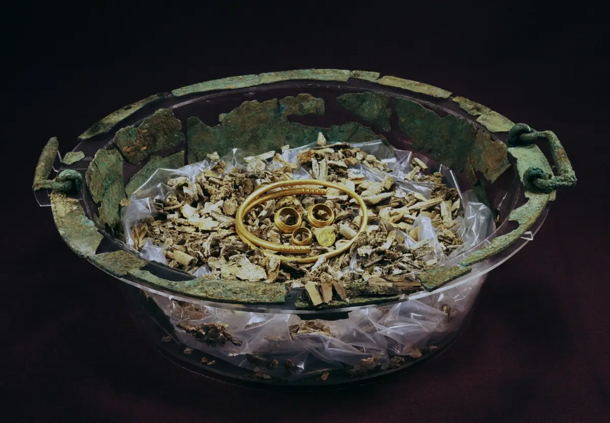 Close-up of the Haramsskatten gold treasure with arm ring and medallion on display at Bergen Museum