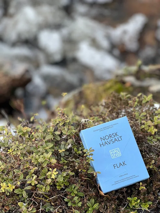 A packet of Havsnø sea salt placed against a backdrop of wild Norwegian nature