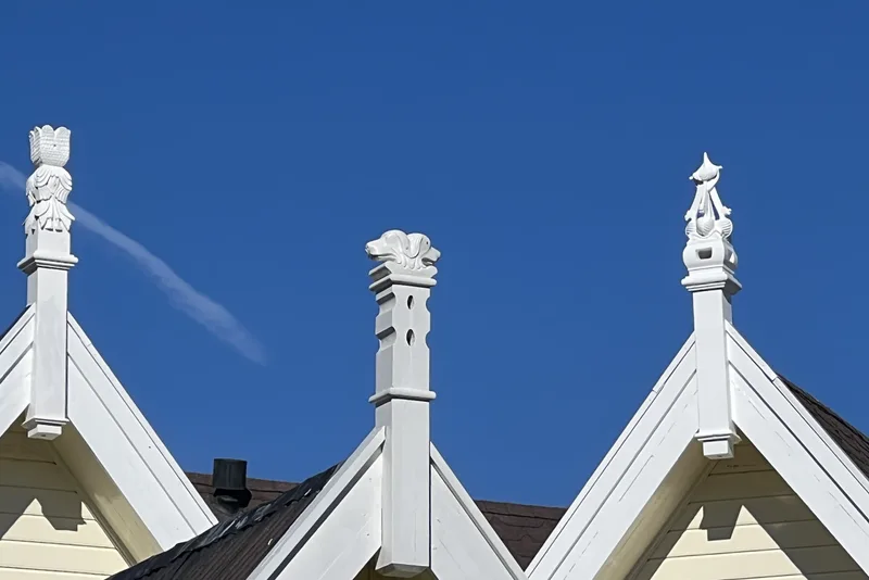Lordehytta seen from the outside, showing its ornate wooden architecture with carved animal figures and multiple gables