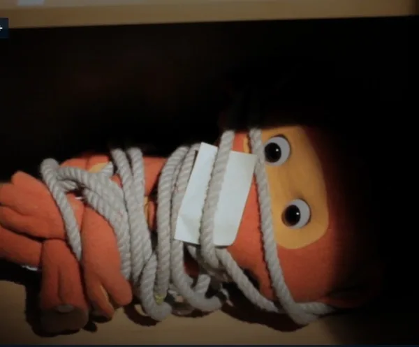 NRK children’s character Fantorangen tied up with rope and gagged with tape in a dramatic scene from the Easter crime series Superkrim