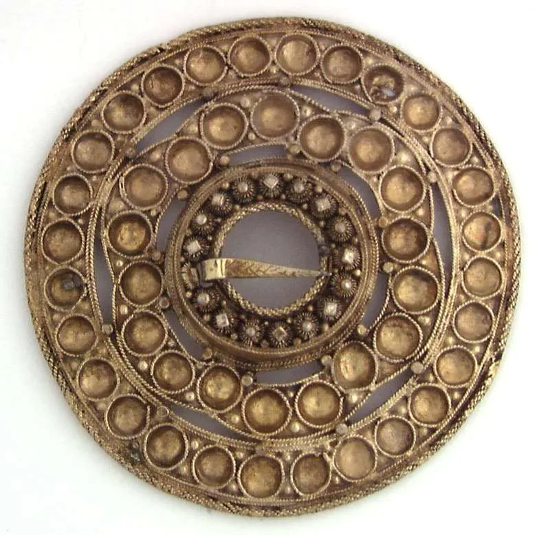 Gilded silver brooch with filigree detailing, purchased in 1896 in Bygland, Setesdal – concentric circles of small gilded domes surround an intricate centre