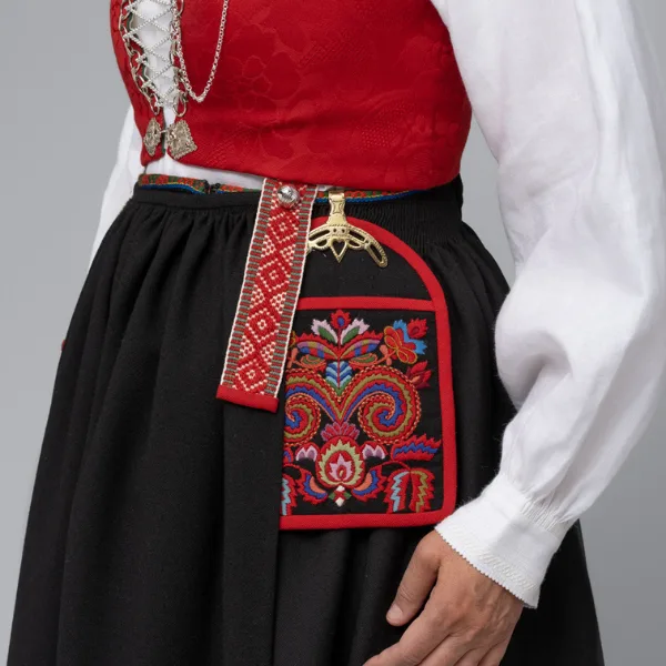 Close-up of a bunad pocket featuring detailed multi-coloured wool embroidery on black fabric