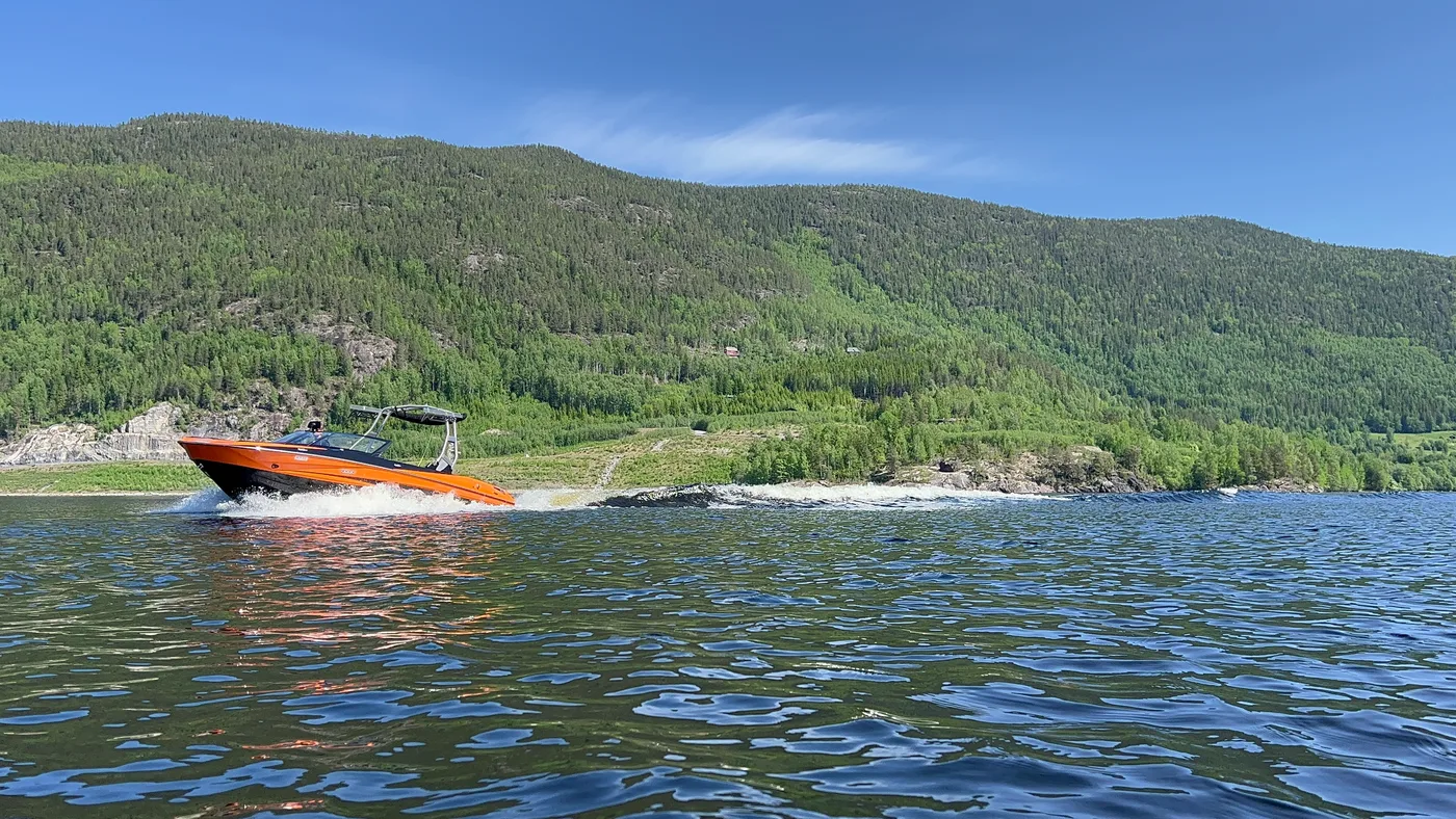Panoramic view of lake Krøderen stretching between forested hillsides in Hallingdal