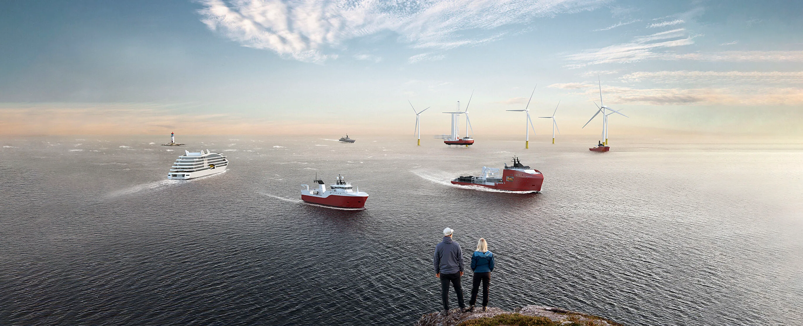 Panoramic view of VARD vessels at sea alongside offshore wind turbines, with two people looking out from a rocky coast.