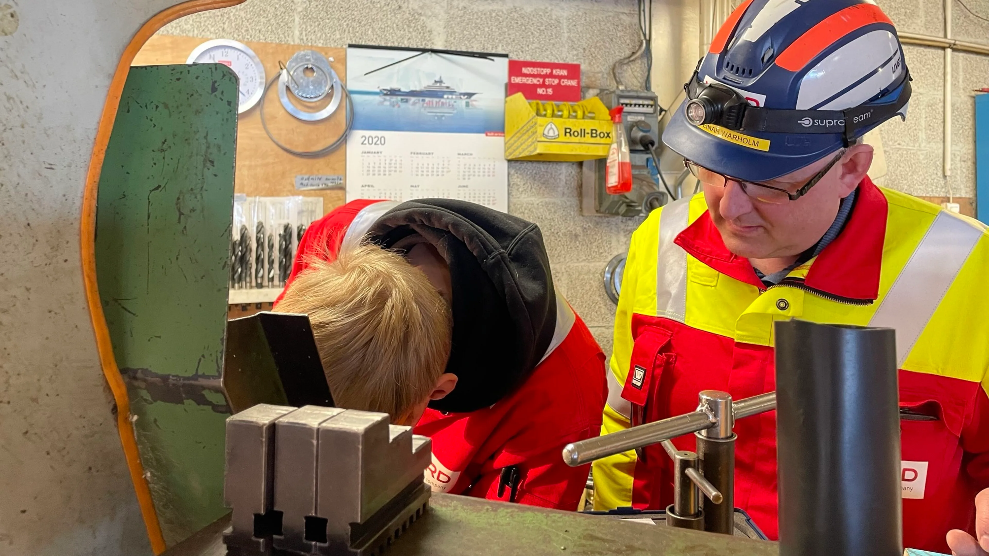 Odd-Einar Warholm watches a young colleague working closely on precision machinery in the VARD workshop.