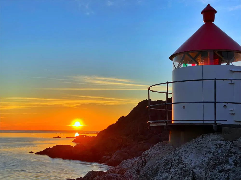 Sunset at the coast near Åna-Sira with a lighthouse