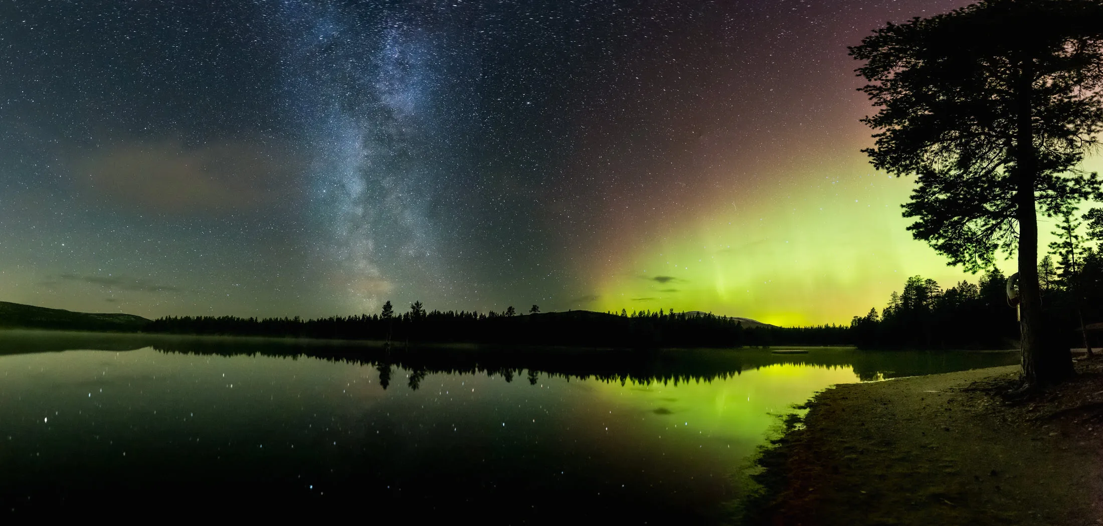 Starry night sky reflected in a mountain lake near Folldal