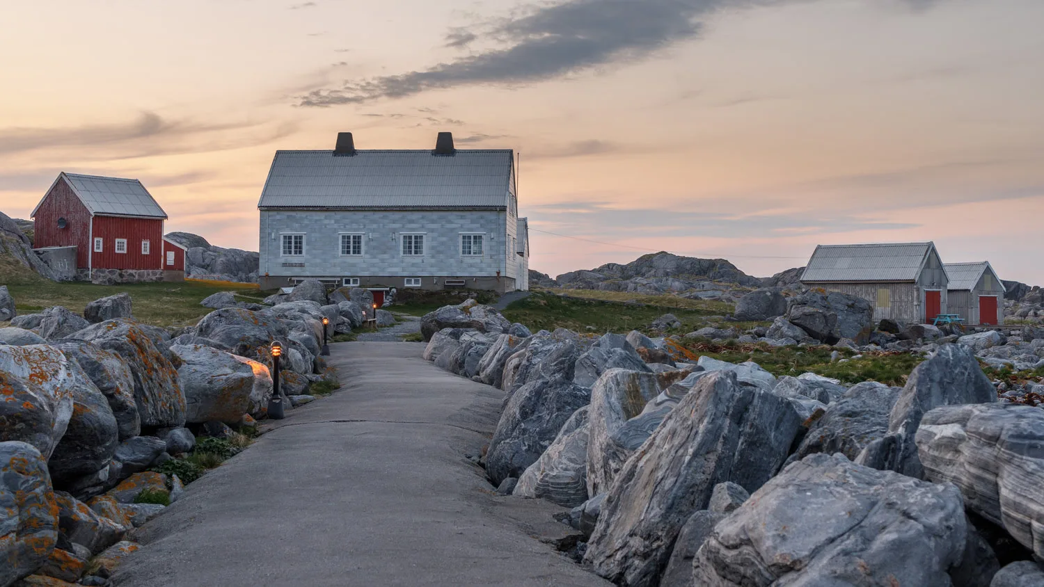 A stone pier leading towards several houses