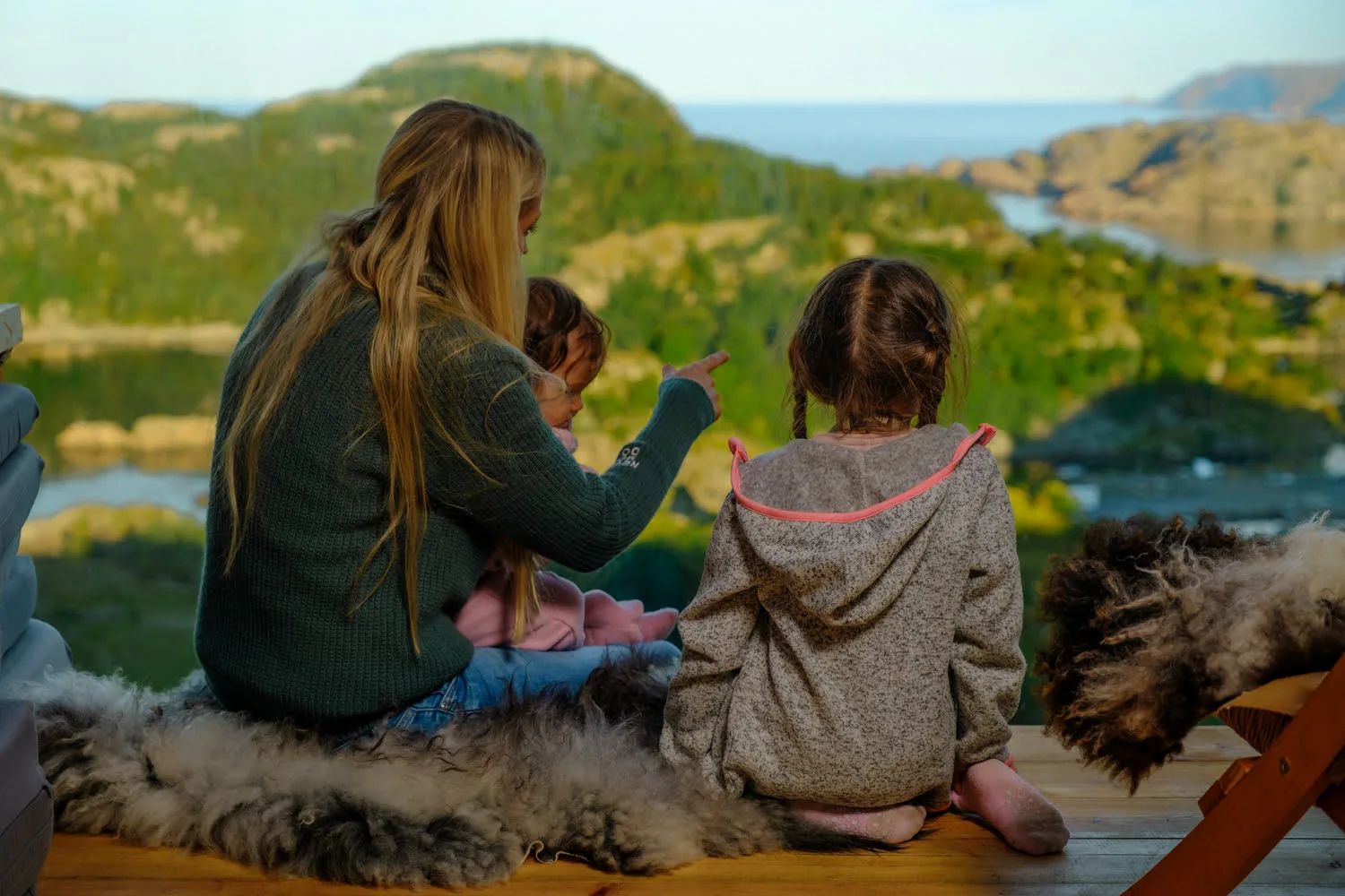 A mother with two children sitting on leather with a great view