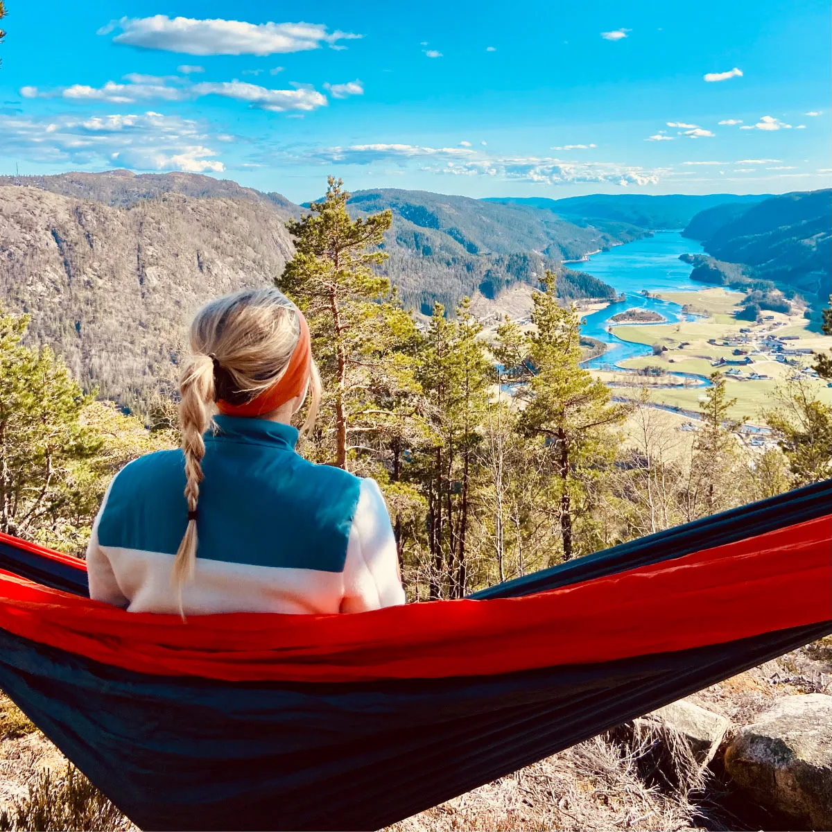 Girl sitting in a hammock looking at a beautiful view