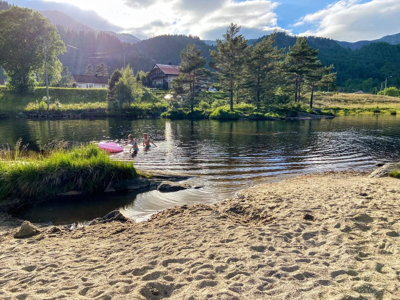 Two kids playing in the water at a beach