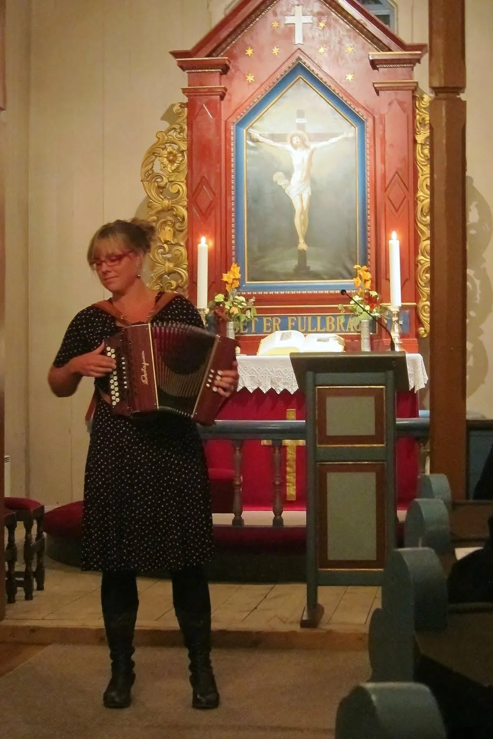 Woman playing accordion in the church in Leveld, Norway
