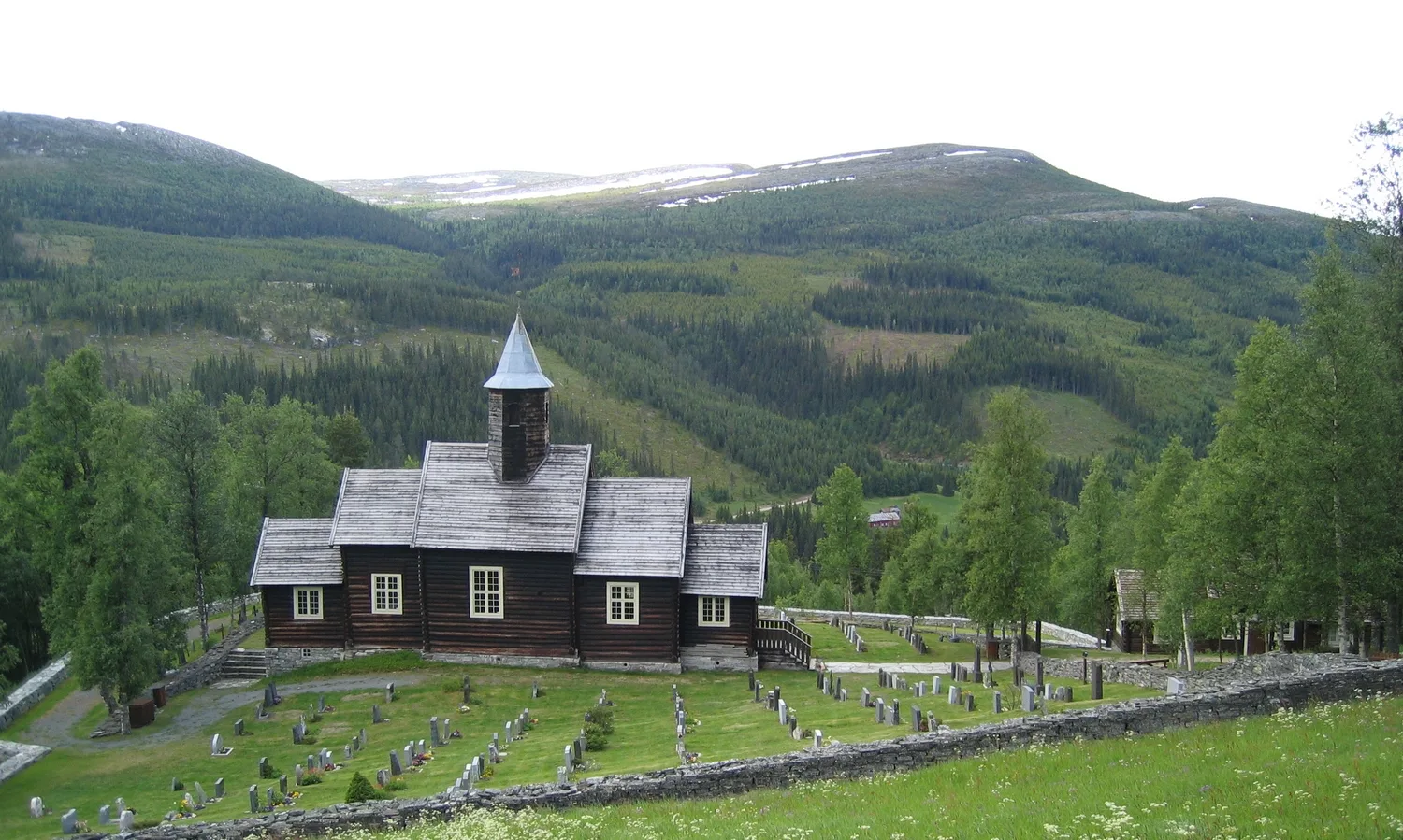 Sollia church surrounded by farmhouses and mountains